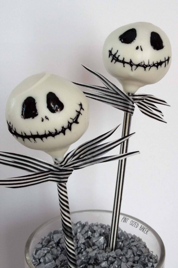 Cake Skellington Cake Pops with black and white decorated sticks to mimic his pin striped suit.