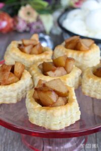 Pear Puffed Pastry Tarts served on a rose colored glass plate.