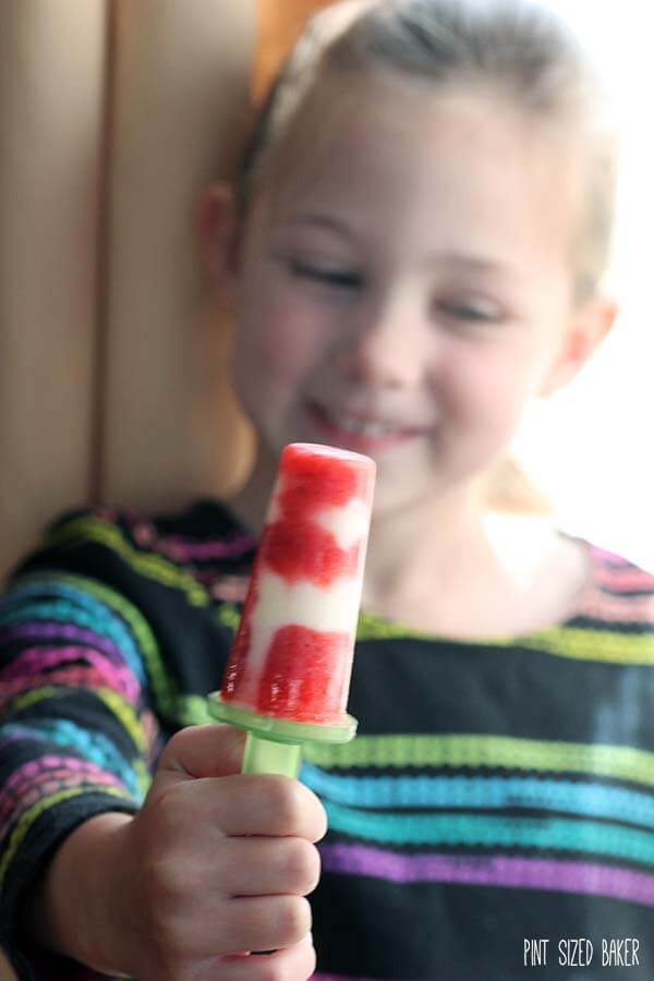 Grab the kids and have them help you make these easy and delicious Strawberry and Yogurt Popsicles. So easy, so fun, and so perfect for a hot day!