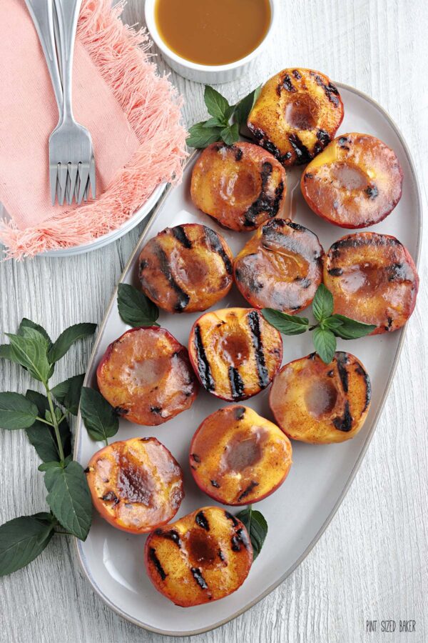 Overhead image of grilled peaches smothered with melted cinnamon butter.