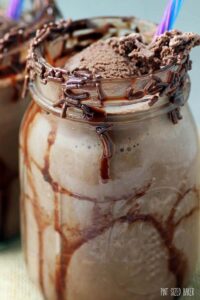 These Triple Chocolate Milkshakes are just what your chocoholic sweet tooth is craving! Chocolate milk, chocolate ice cream, and chocolate syrup - YUM!