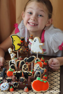 Grab your little ghouls and witches to make this fun Halloween Graveyard Cake with cookie decorations.