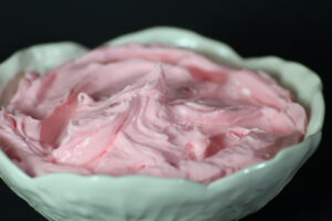 Perfect peaks in a pink Swiss Buttercream frosting that is perfect for a cake.