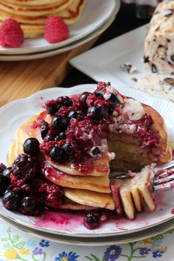Layers of Lemon Ricotta Pancakes covered with mixed berries and blueberry butter. from #dietersdownfall.com