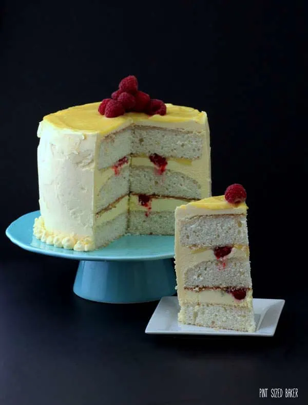 Lemon sponge cake with homemade layer curd and pops of fresh raspberries. This Raspberry and Lemon Layer Cake is simply stunning!