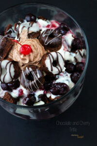 A decadent Trifle made with chocolate baked doughnuts, homemade white chocolate pudding and cherry pie filling. OH MY!!