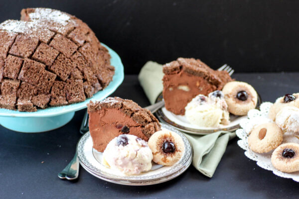 Chocolate Zuccotto (bomb cake) with a light spongy cake exterior and filled with chocolate mousse and cherries served with Buttermilk Ice Cream and Amaretti Cookies.