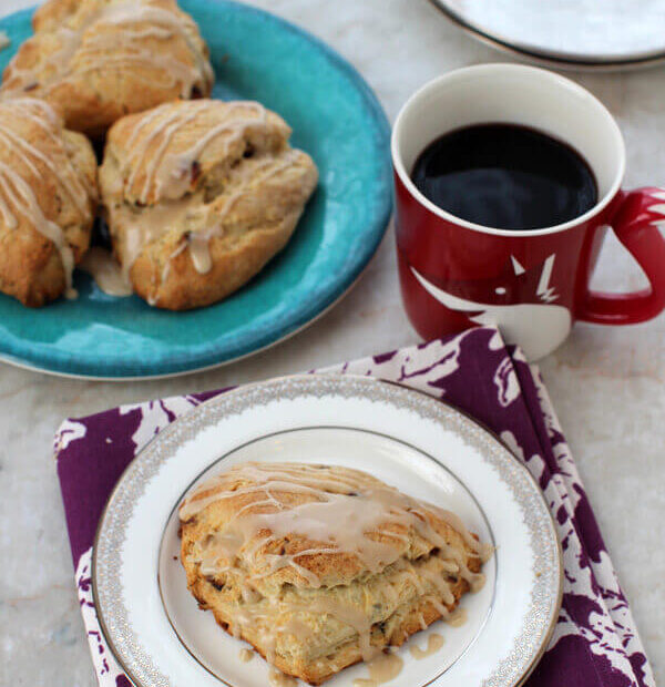 Maple Scones on a small plate with a cup of coffee.