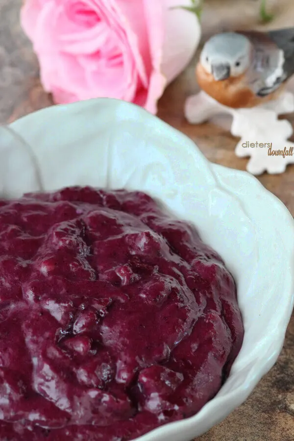 Beautiful color of homemade blueberry jam cooked and turned into blueberry curd with walnuts.