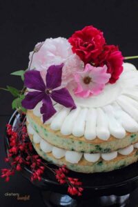 Mint Chip Cake with vanilla bean frosting with edible flowers.
