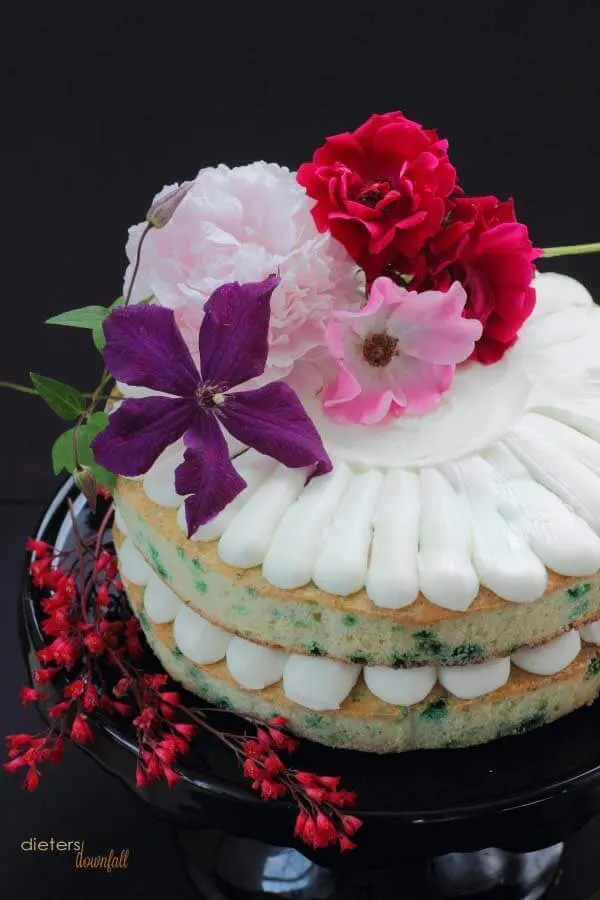 Mint Chip Cake with vanilla bean frosting with edible flowers.
