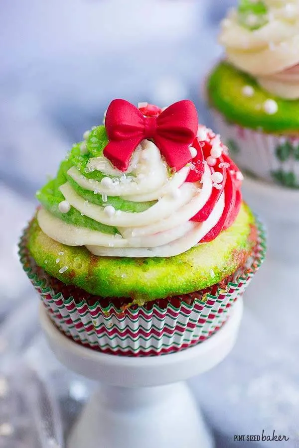 Perfect Christmas Cupcakes with easy red, green, and white frosting. Topped with a pretty bow and sprinkles.