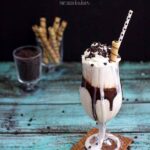 A decadent, yet easy, Vanilla Milkshake with a chocolate ribbon in the glass and chocolate chips on top! Perfect for a weeknight snack!