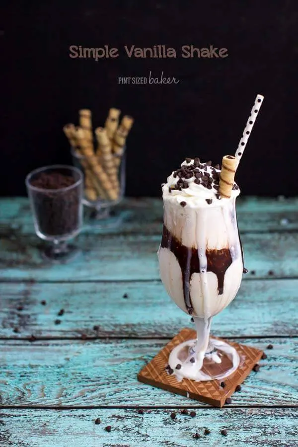 A decadent, yet easy, Vanilla Milkshake with a chocolate ribbon in the glass and chocolate chips on top! Perfect for a weeknight snack!
