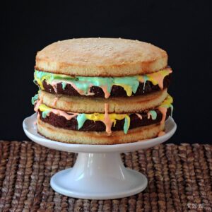 Surprise the men in your life with this fun and delicious Big Mac Cake! It's Three layers of Yellow Cake with Fudgy Brownies and seven minute frosting.