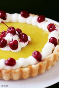 A delicious lime curd filling with a lime tart crust and homemade whipped cream and maraschino cherries.