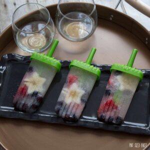 Fresh blueberries, apples, and strawberries are added to this fun and delicious White Wine Spritzer Popsicles.