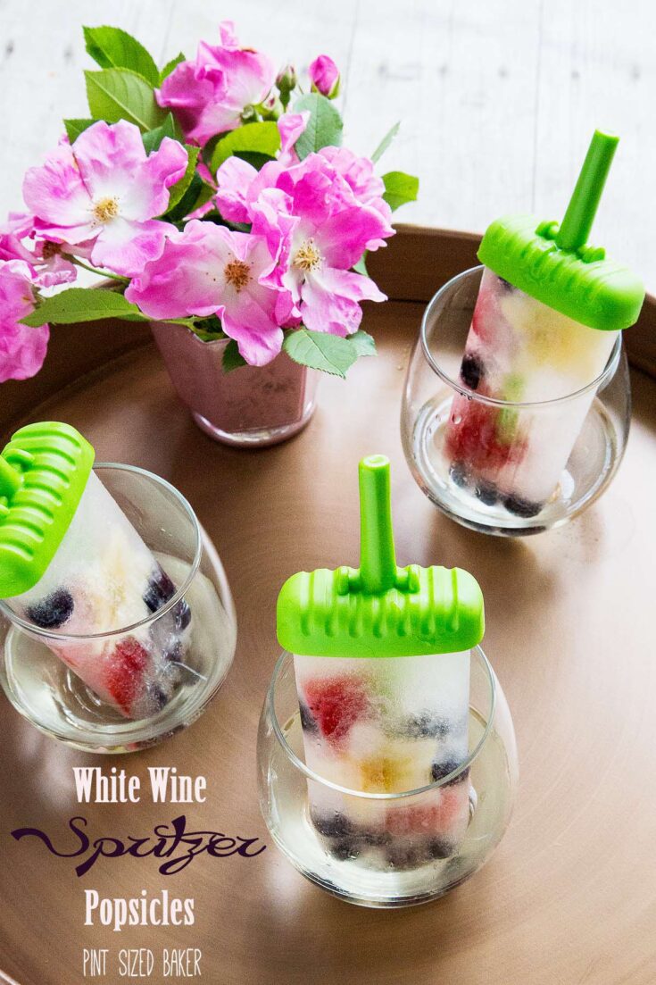 Sweet white wine, some fresh berries and a hint of seltzer makes these White Wine Spritzer Popsicles a hit this summer.
