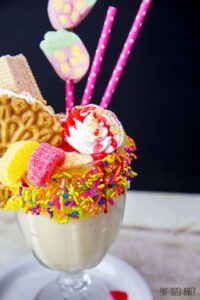 This Lemon Meringue Milkshake is topped with a lemon ice cream sandwich, strawberry wafer cookies, fruit gummies, marshmallow cream, and a fun strawberry marshmallow decoration. The kids loved it!
