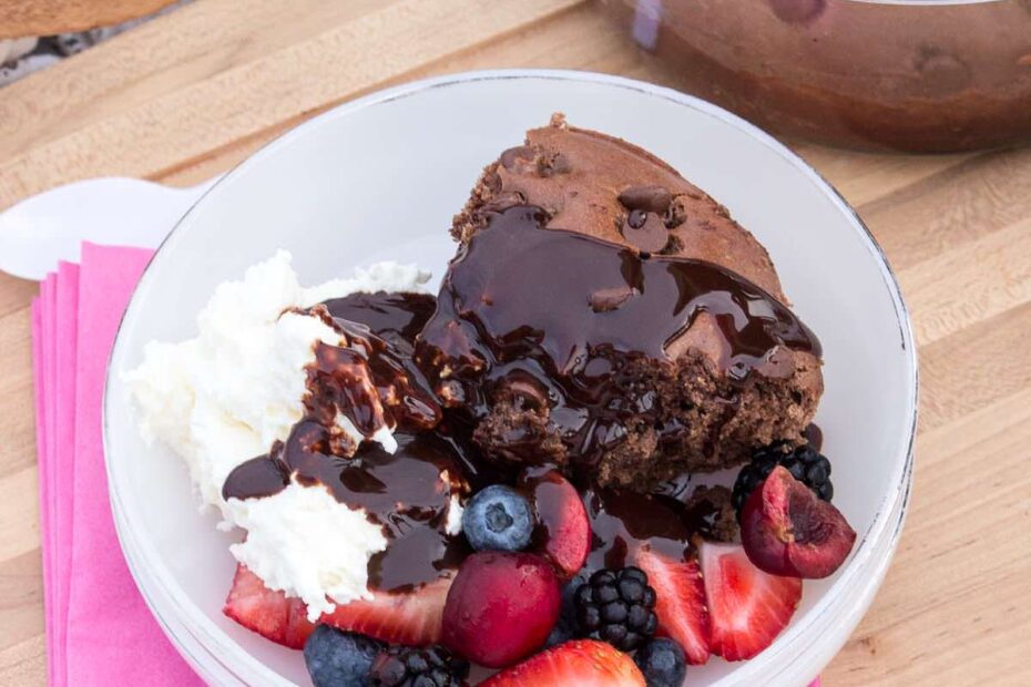 Picnic Chocolate Cake with fresh fruit, whipped cream and chocolate sauce all served at the park.