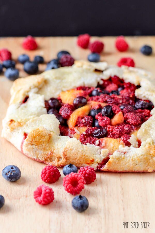 An Galette is an easy dessert that you can whip up quickly. No time for a pie? A galette is a great alternative. This Wineberry Galette is also flavored with peaches and blueberries.