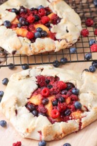 An Galette is an easy dessert that you can whip up quickly. No time for a pie? A galette is a great alternative. This Wineberry Galette is also flavored with peaches and blueberries.