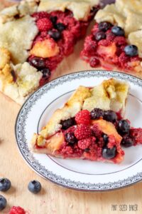 An Galette is an easy dessert that you can whip up quickly. No time for a pie? A galette is a great alternative. This Wineberry Galette is also flavored with peaches and blueberries.