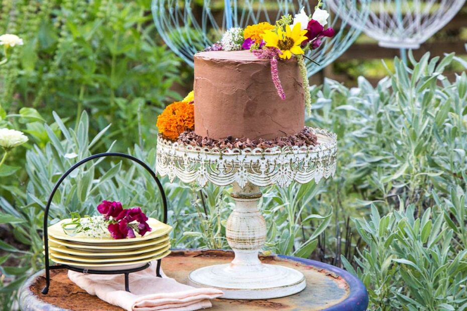 4 layer Chocolate Cake decorated with fresh picked edible flowers. The perfect dessert for the perfect day!