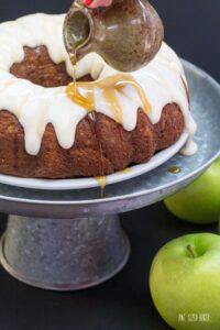 Dig into this Apple Spice Bundt Cake with decadent cream cheese frosting and a drizzle of maple syrup .