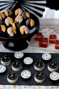 It's a No Bake dessert table that fun for everyone! Fortune Cookies, Oreo Cookie Clocks and Strawberry Champagne Jello shots!