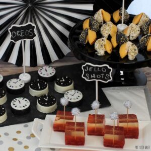 Ring in a New Year with a no-fuss, no-bake dessert table with Fortune Cookies, Oreo Cookie Clocks and Strawberry Champagne Jello shots!