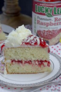 So stunning! This White Chocolate Raspberry Cake is made easy with a cake mix and @LuckyLeaf raspberry pie filling.