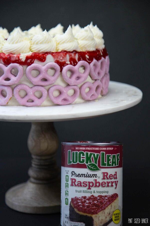 So stunning! This White Chocolate Raspberry Cake is made easy with a cake mix and @LuckyLeaf raspberry pie filling.