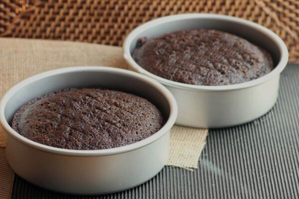 Simple yet decadent Chocolate Cake Recipe that is the perfect base for many different buttercream frostings. Makes two 9" cakes that are great for stacking.