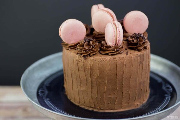 Bake a beautiful Chocolate Cake with Macarons for someone special. The cake and frosting is homemade, but the macarons are store bought.