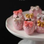 Pink Chocolate Covered Strawberries with pretty bows on. All dressed up for a thrilling New Years Eve or a fun Great Gatsby Party.