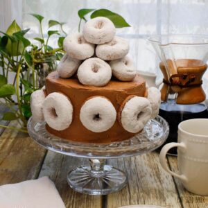 This Coffee and Donuts Cake is Homer Simpson approved! It's loaded with coffee flavor and covered with powdered sugar doughnuts. Yum!