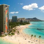 The Hilton Hawaiian Village with its iconic Rainbow Tower overlooks Waikiki with Diamond Head in the background. Droning in Hawaii