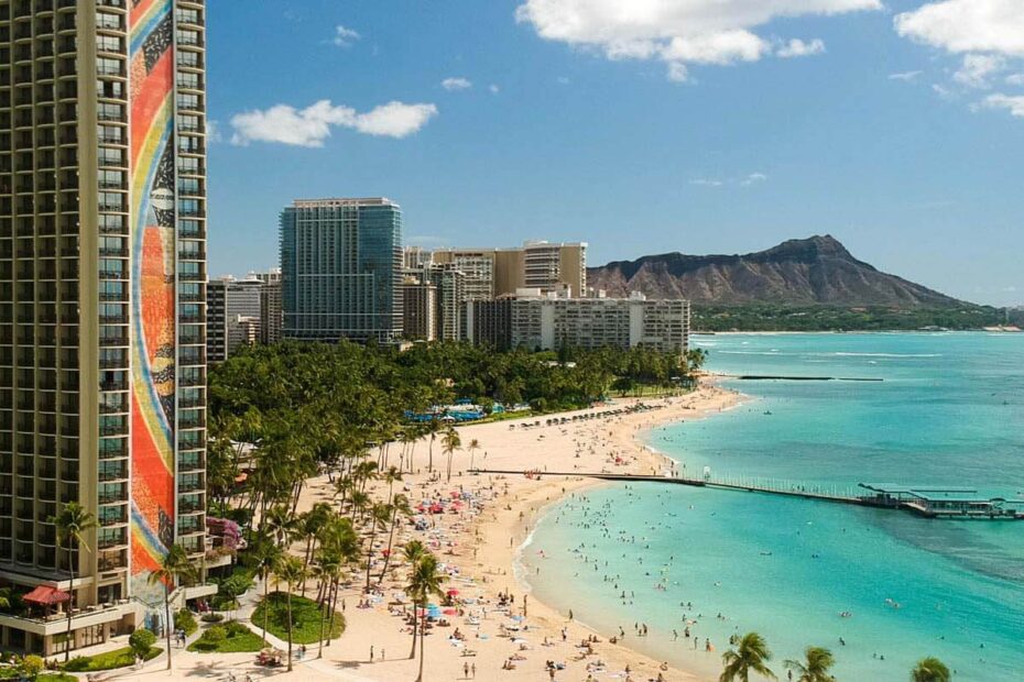 The Hilton Hawaiian Village with its iconic Rainbow Tower overlooks Waikiki with Diamond Head in the background. Droning in Hawaii