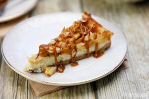 This quick and easy Almond Apple Cheesecake Recipe is going to be your new favorite treat. It combines sweet cinnamon apples with cheesecake that is perfect some caramel sauce.