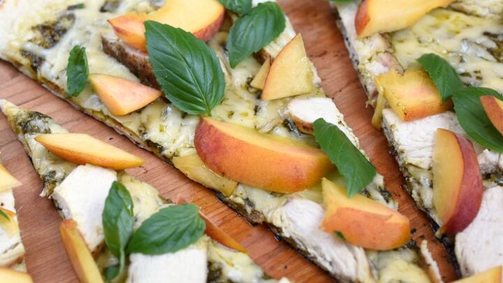 Sweet peaches salty Gruyere and a grilled crust combine to make an amazing Grilled Chicken and Peach Pesto Pizza that everyone will love © COOKING WITH CURLS