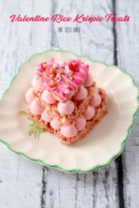 Everybody loves pink food! These Strawberry Valentine Rice Krispie Treats are made with pink Rice Krispie Cereal and strawberry pink frosting!