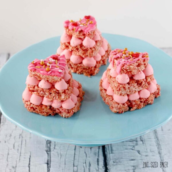 Everybody loves pink food! These Strawberry Valentine Rice Krispie Treats are made with pink Rice Krispie Cereal and strawberry pink frosting!