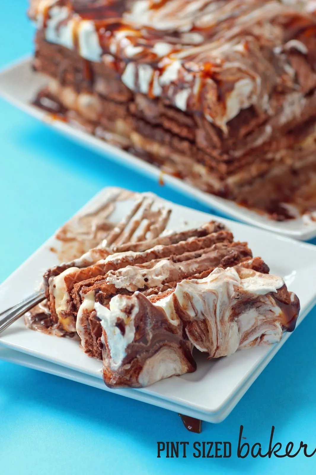 A chocolate wafer icebox cake on a blue background