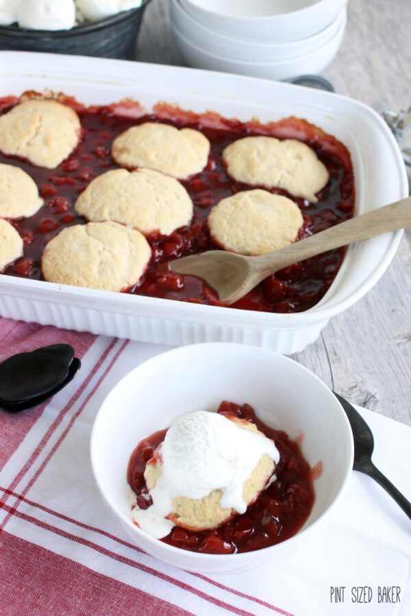 Sour Cherry Cobbler served in a bowl with Vanilla Ice Cream on top.