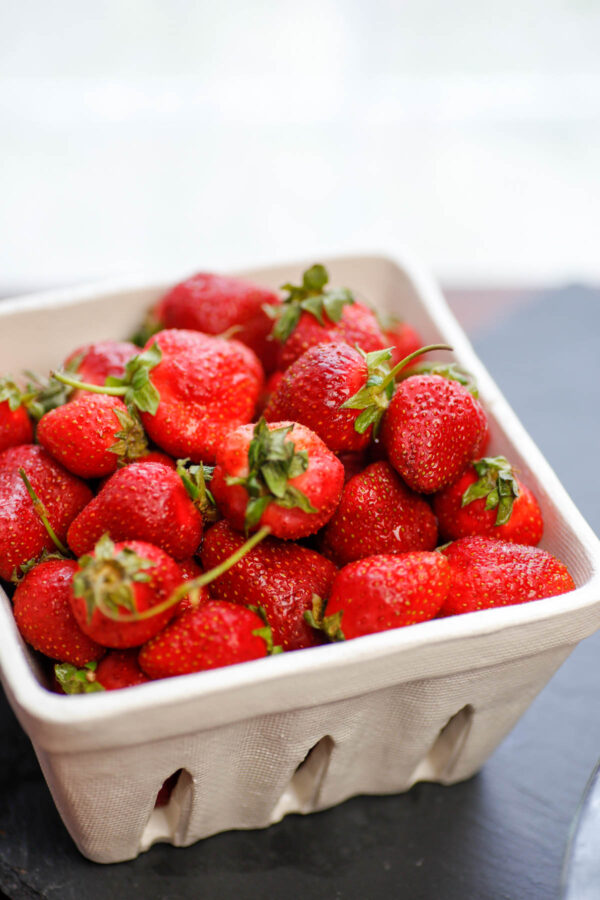 A container of fresh picked strawberries.