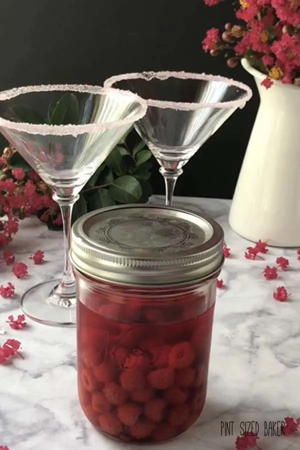 A mason jar of infused winberry vodka.