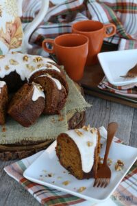 Slice of delicious bundt cake on a plate with icing and a fork ready to be eaten!