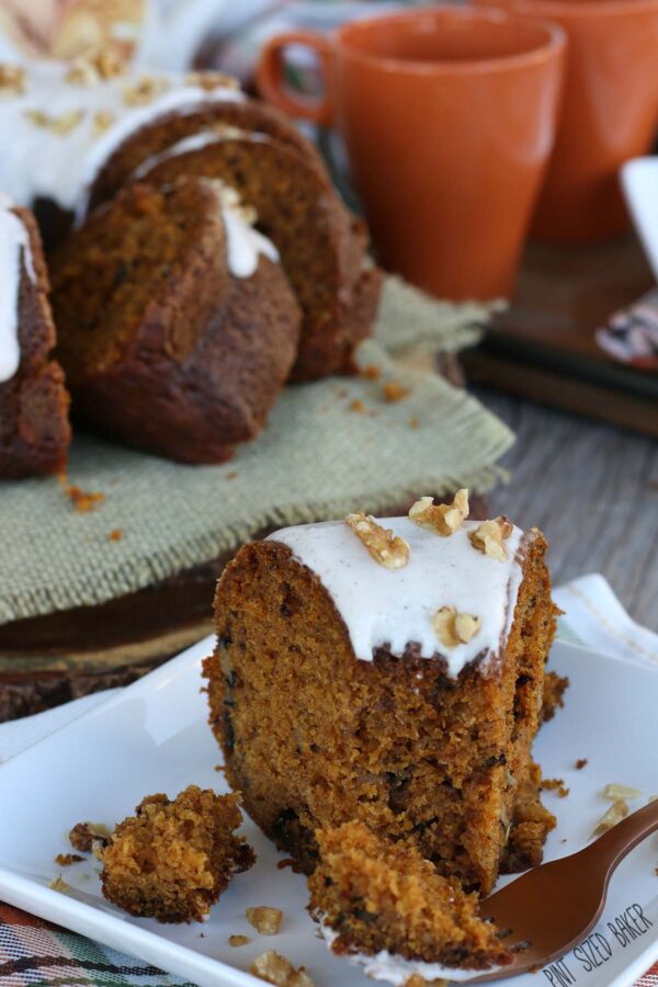 Up close shot of this great pumpkin bundt cake with icing. A bite taken out of it and ready to eat! 