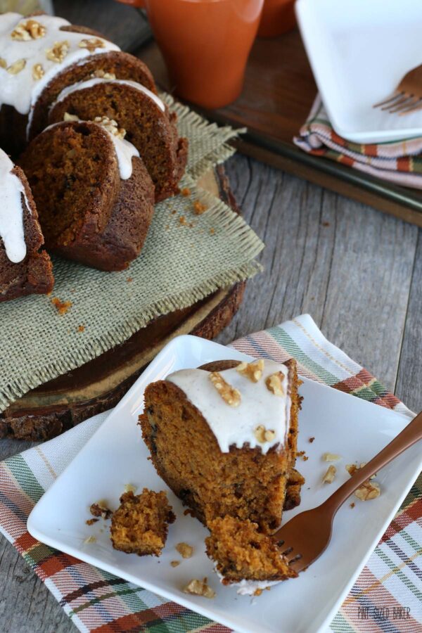 Piece of bundt cake pumpkin recipe on a plate with a fork ready to be enjoyed. 